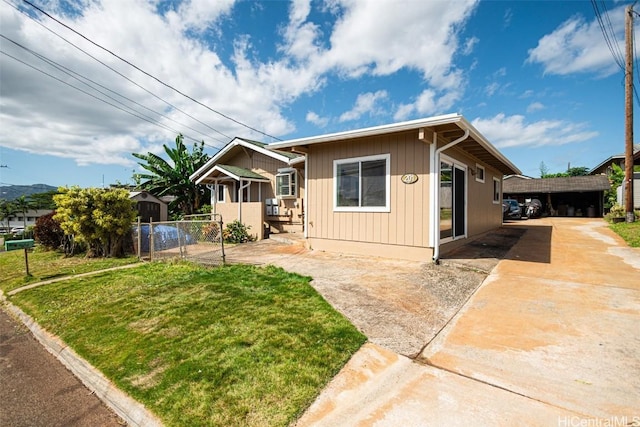 bungalow-style house with a gate, fence, and a front lawn