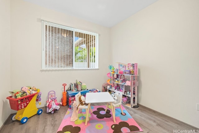 game room with light hardwood / wood-style floors