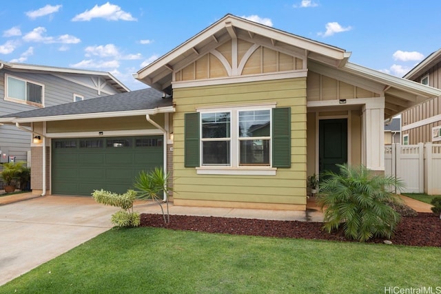 view of front of home with a front yard and a garage