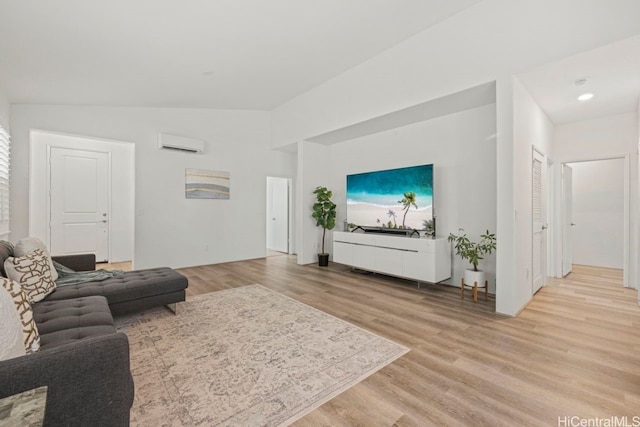 living room featuring a wall mounted AC and light wood-type flooring