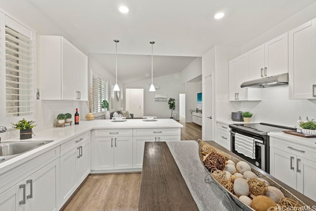 kitchen with light hardwood / wood-style flooring, vaulted ceiling, decorative light fixtures, stainless steel electric range, and white cabinets