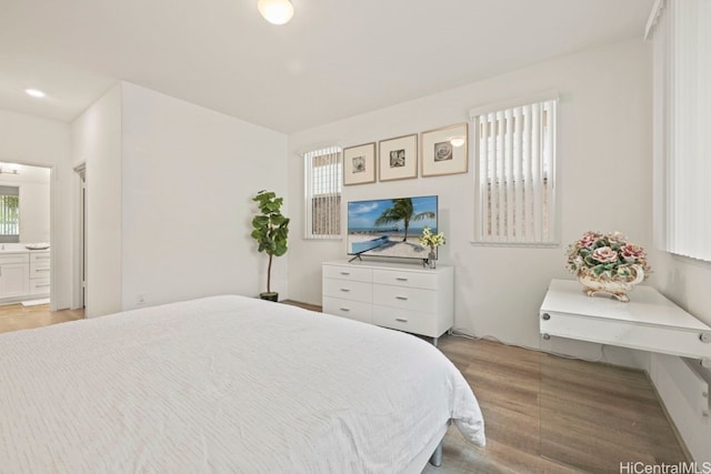 bedroom featuring multiple windows and ensuite bath