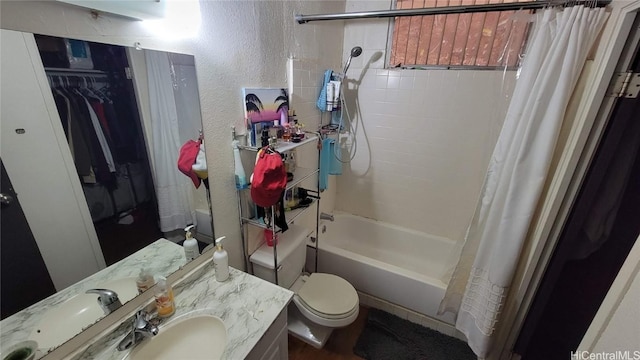 full bathroom featuring vanity, toilet, and shower / tub combo