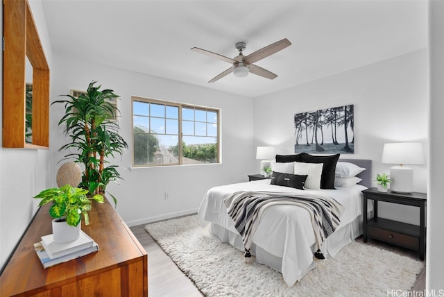 bedroom with hardwood / wood-style flooring and ceiling fan