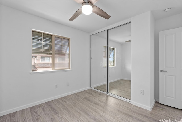 unfurnished bedroom with ceiling fan, multiple windows, and a closet