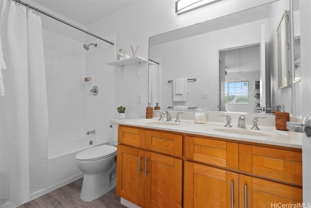 full bathroom with hardwood / wood-style floors, vanity, toilet, and shower / bath combination with curtain