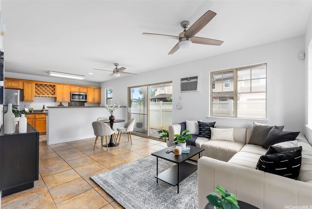 91-1171 Kaiau Ave Unit 207, Kapolei, HI 96707 - living room featuring a ceiling fan, a wall unit AC, and light tile patterned floors