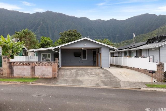 ranch-style home featuring a carport and a mountain view