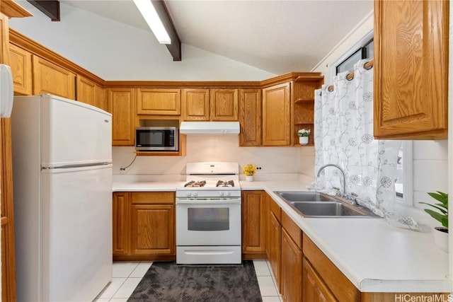 kitchen with vaulted ceiling with beams, light tile patterned flooring, white appliances, and sink