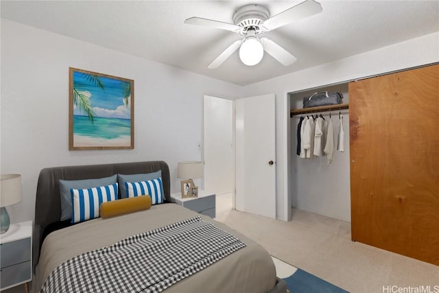 bedroom with ceiling fan, a closet, and carpet