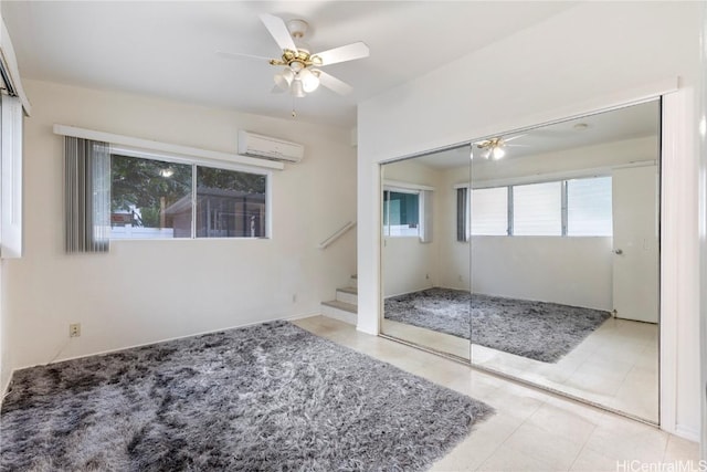 entrance foyer with a wall mounted air conditioner and ceiling fan