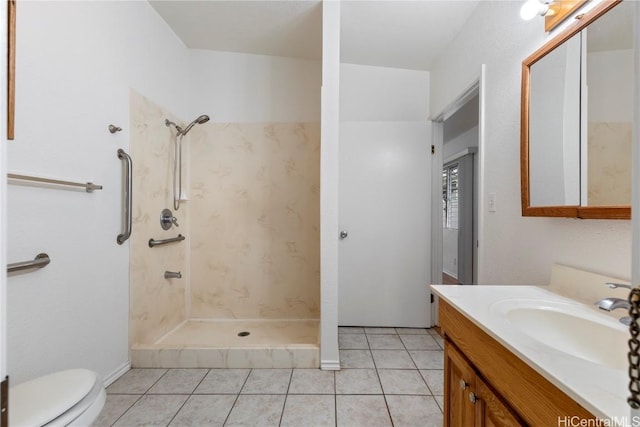 bathroom with tile patterned flooring, vanity, toilet, and walk in shower