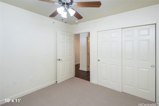 unfurnished bedroom with carpet flooring, a closet, and ceiling fan