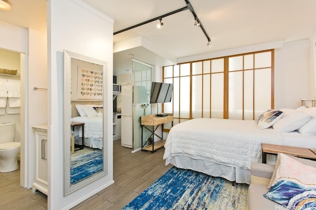 bedroom featuring track lighting