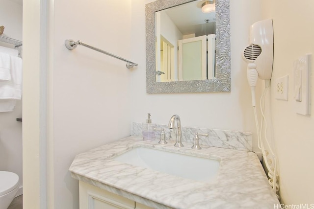 bathroom with vanity and toilet