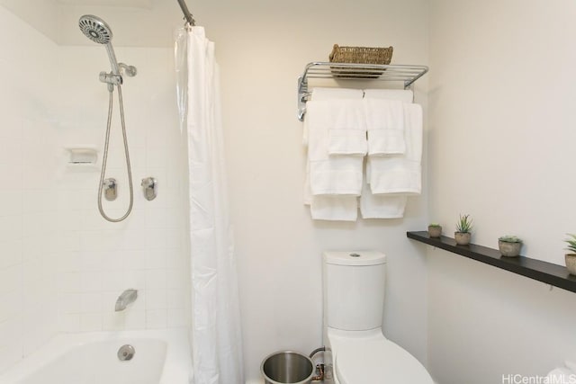 bathroom with shower / tub combo and toilet