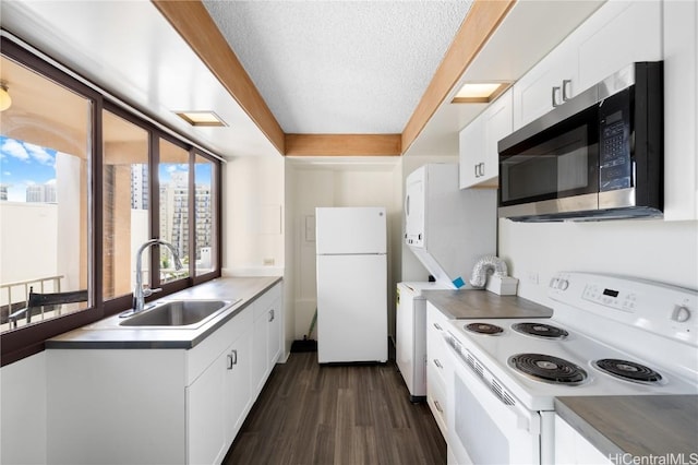 kitchen with white appliances, white cabinets, sink, a textured ceiling, and dark hardwood / wood-style flooring