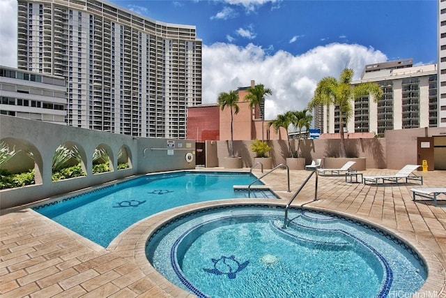 view of pool with a community hot tub and a patio area