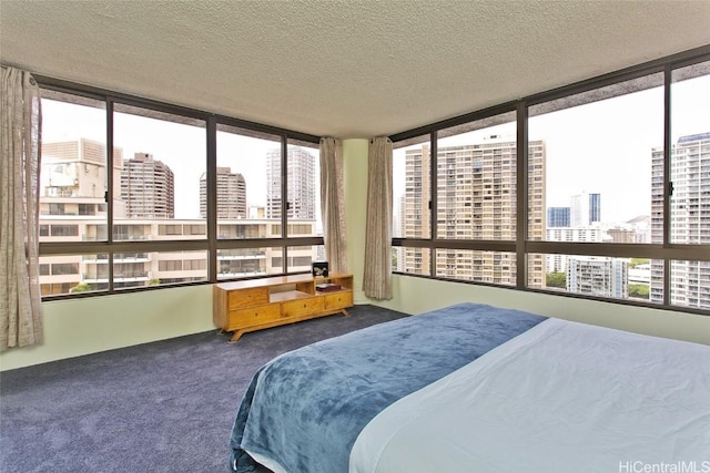 bedroom featuring carpet flooring and a textured ceiling