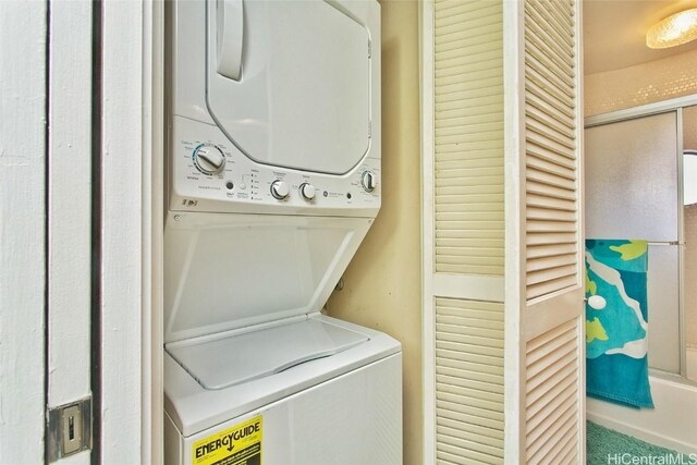 washroom featuring stacked washer and dryer