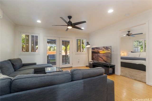 living room featuring ornamental molding, ceiling fan, french doors, and light hardwood / wood-style flooring