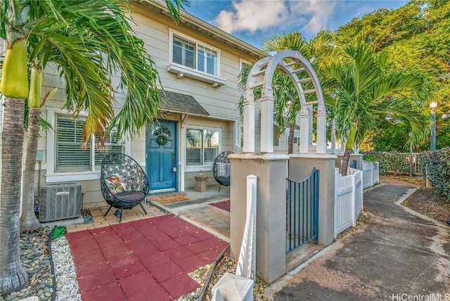 doorway to property featuring central air condition unit and a patio