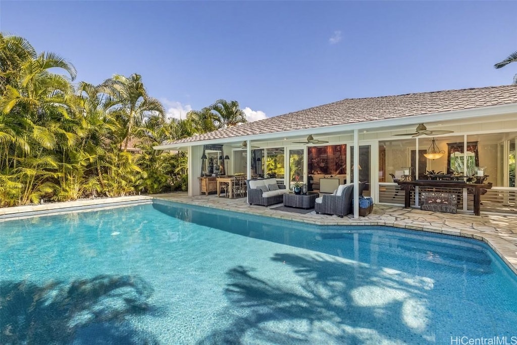 view of swimming pool featuring ceiling fan, an outdoor living space, and a patio