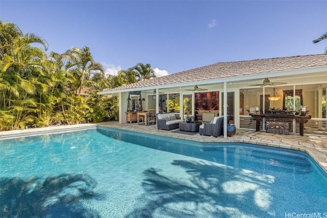 view of swimming pool featuring ceiling fan, an outdoor living space, and a patio