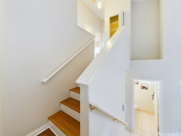 stairway with tile patterned floors