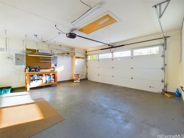 garage with a workshop area, electric panel, and a garage door opener