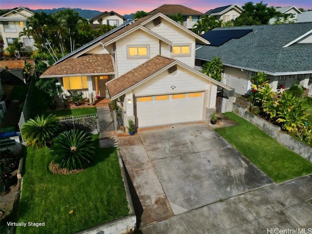 view of front of house with a garage and a lawn