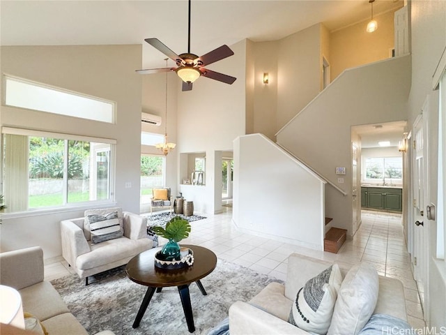 tiled living room featuring a wall mounted air conditioner, ceiling fan with notable chandelier, sink, and high vaulted ceiling