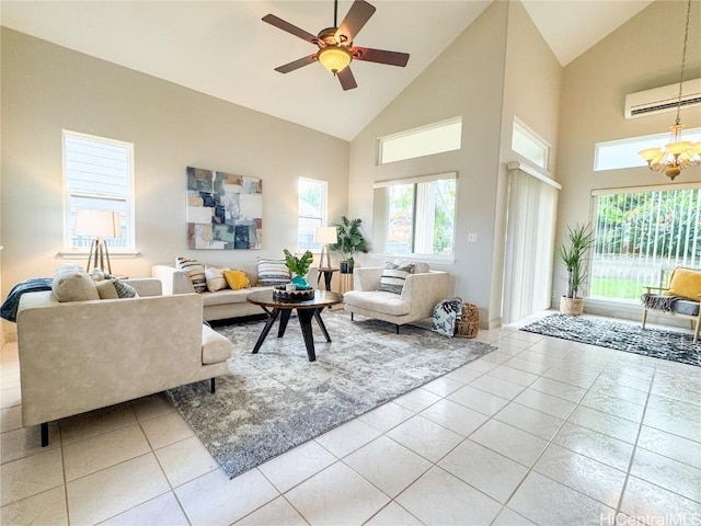 tiled living room with ceiling fan with notable chandelier, high vaulted ceiling, a wall mounted AC, and a healthy amount of sunlight