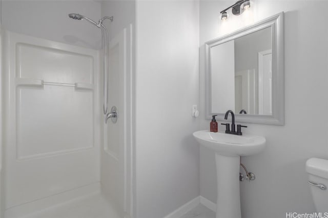 bathroom featuring toilet and walk in shower