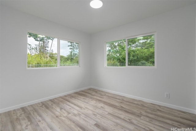 spare room featuring light wood-type flooring