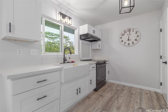 kitchen with white cabinets, sink, black range with electric cooktop, and light hardwood / wood-style floors