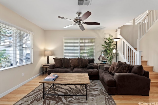 living room with ceiling fan and light hardwood / wood-style floors