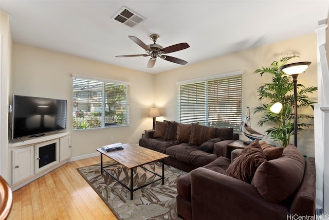 living room featuring ceiling fan and light hardwood / wood-style flooring