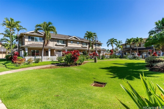 view of home's community featuring a lawn