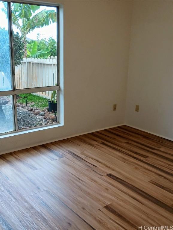 spare room featuring wood-type flooring