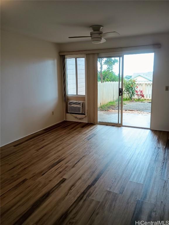 unfurnished room with cooling unit, ceiling fan, and wood-type flooring