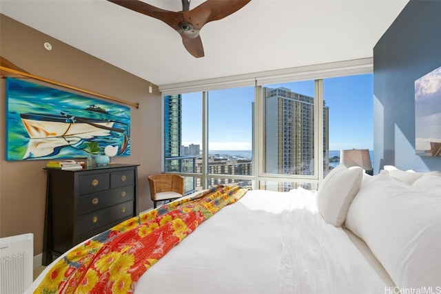 bedroom featuring ceiling fan and floor to ceiling windows