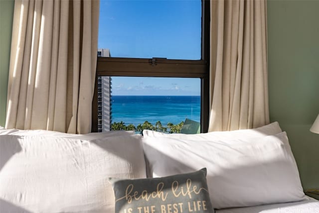 bedroom featuring a water view