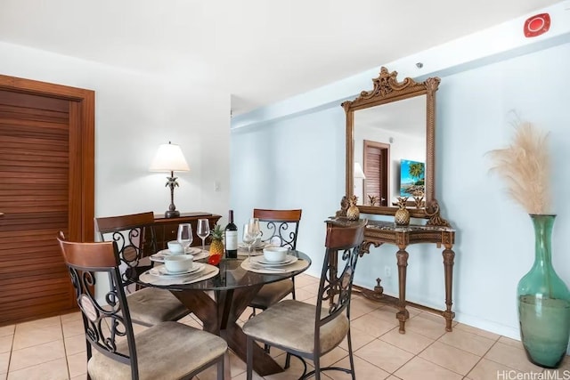 dining space featuring light tile patterned floors