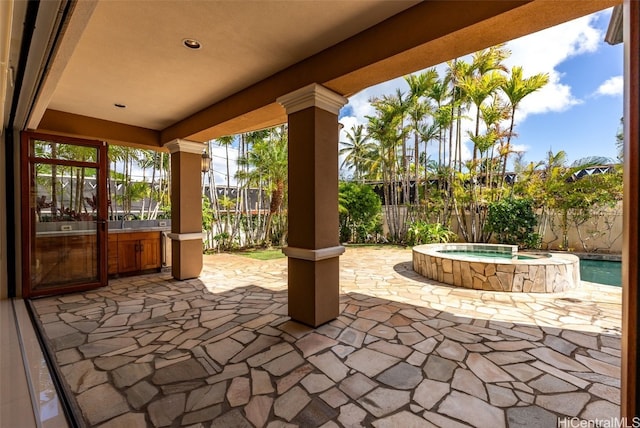 view of patio with an in ground hot tub