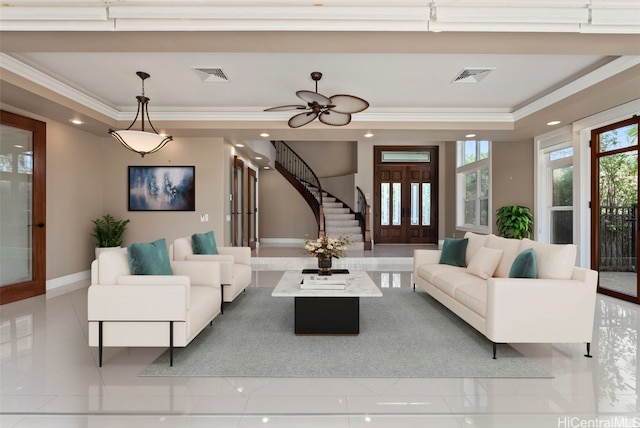 tiled living room with ceiling fan, crown molding, a raised ceiling, and french doors