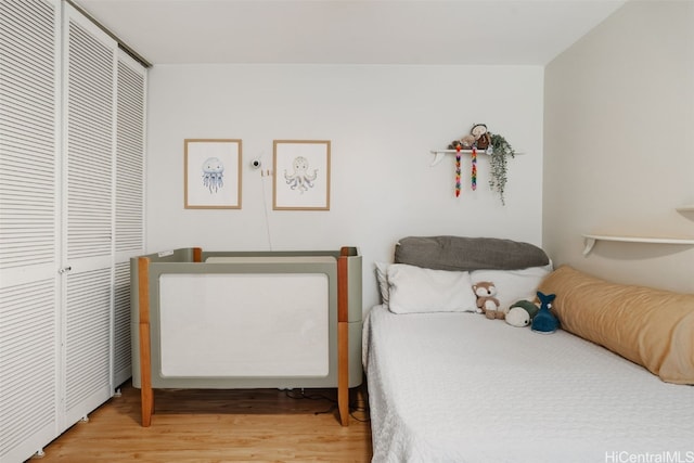 bedroom with hardwood / wood-style floors and a closet