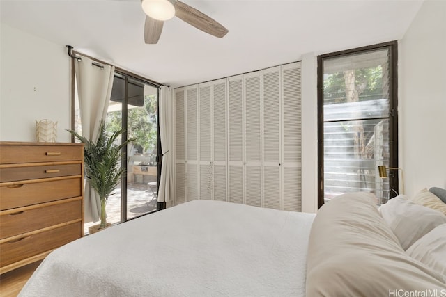 bedroom with ceiling fan, a closet, and access to outside