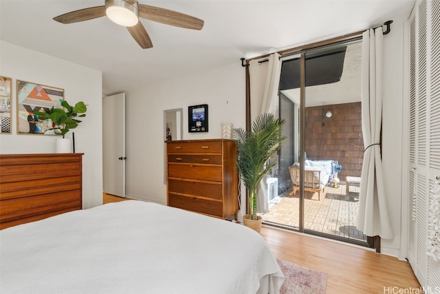 bedroom with light wood-type flooring, ceiling fan, and access to outside