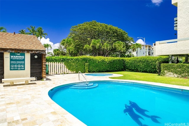 view of swimming pool with an in ground hot tub and a patio